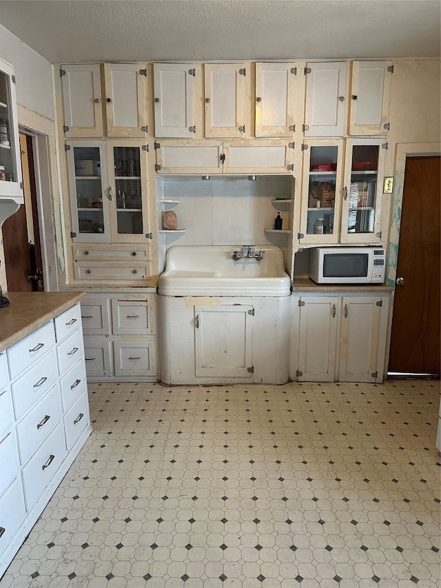 kitchen with sink and a textured ceiling