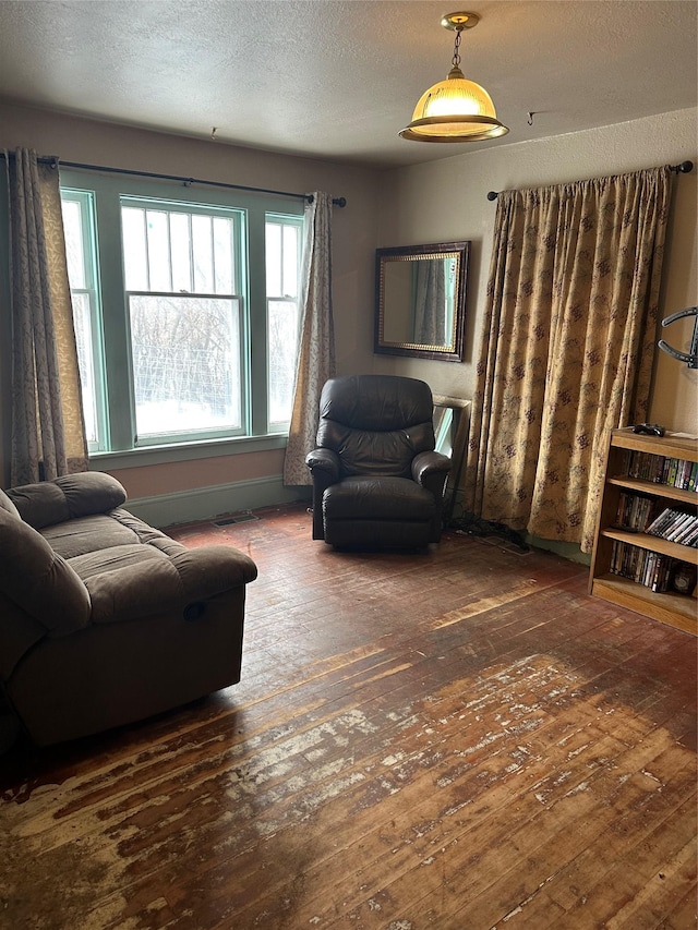 living room featuring a textured ceiling and dark hardwood / wood-style flooring