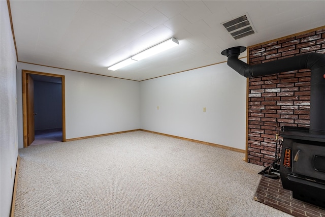 unfurnished living room featuring carpet flooring and a wood stove