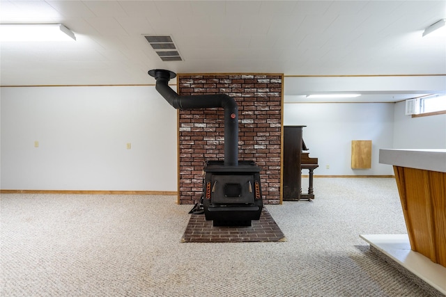 unfurnished living room featuring carpet floors and a wood stove