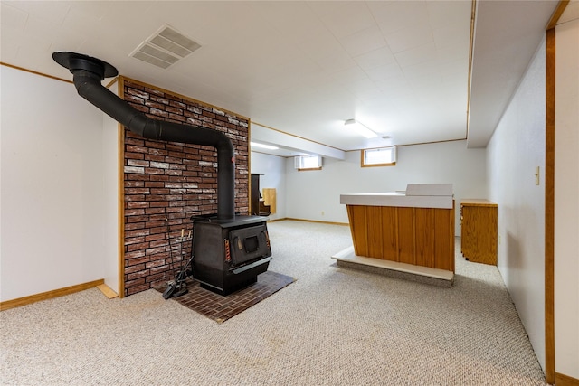 interior space with carpet floors and a wood stove