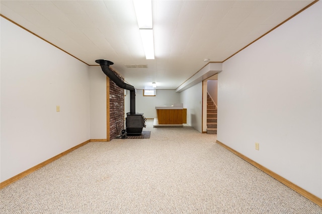 basement with carpet and a wood stove