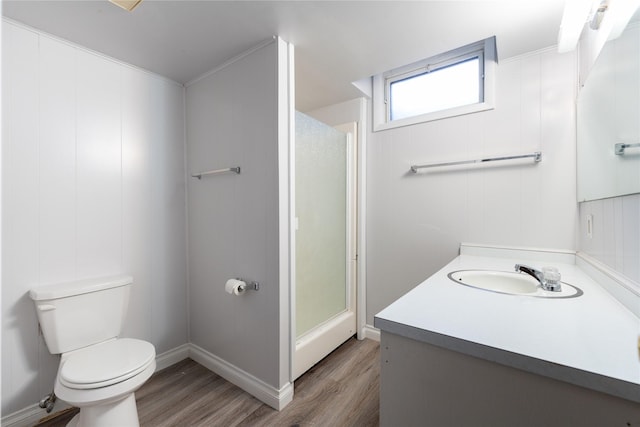 bathroom featuring vanity, hardwood / wood-style flooring, toilet, and walk in shower