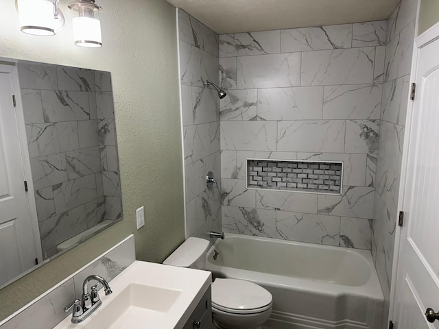 full bathroom featuring tiled shower / bath, vanity, and toilet