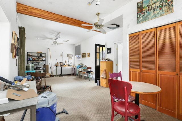 carpeted dining space featuring lofted ceiling with beams and ceiling fan