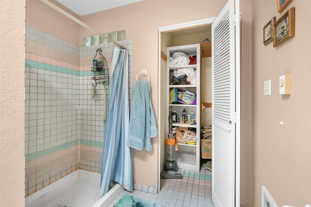 bathroom featuring a shower with curtain and tile patterned flooring