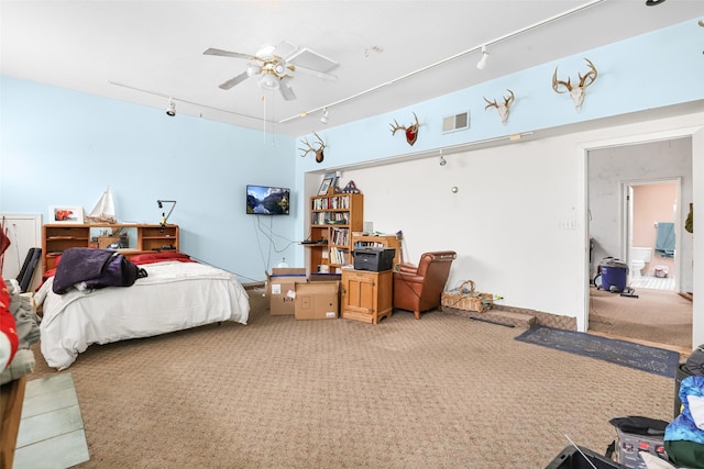 carpeted bedroom with ceiling fan and track lighting