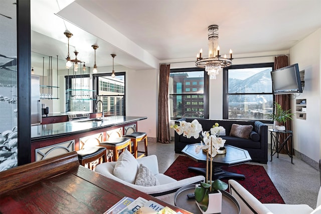 living room with an inviting chandelier and sink