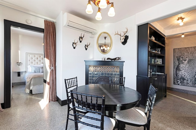 dining area with a tile fireplace, a wall mounted air conditioner, and a notable chandelier