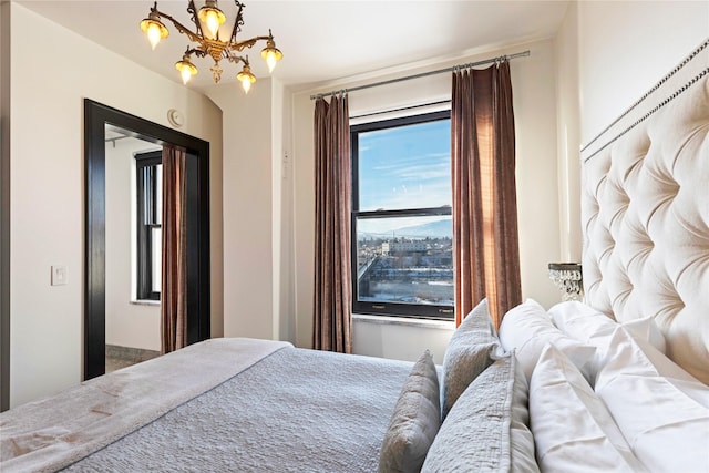 bedroom featuring a notable chandelier