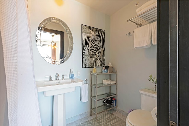 bathroom featuring tile patterned floors, toilet, and curtained shower