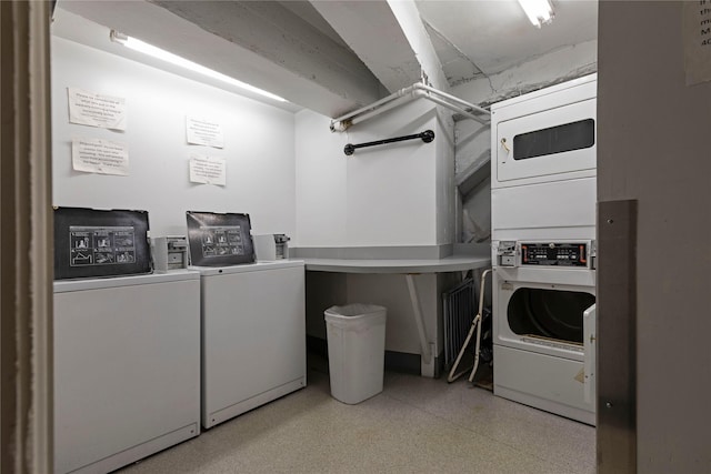 laundry area with stacked washer and clothes dryer and washing machine and clothes dryer