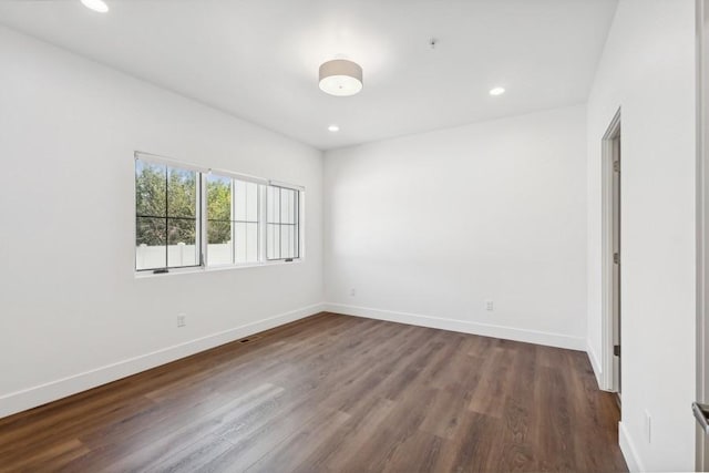 empty room with dark wood-type flooring