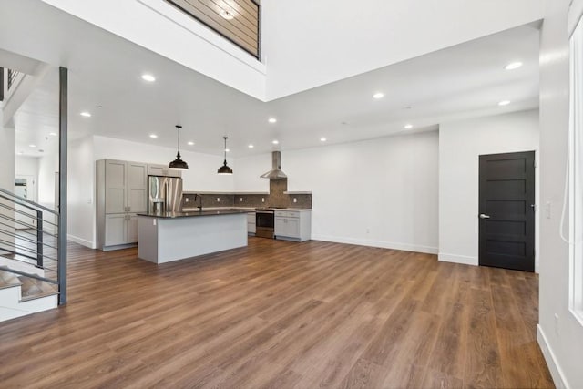 unfurnished living room with dark hardwood / wood-style flooring and sink