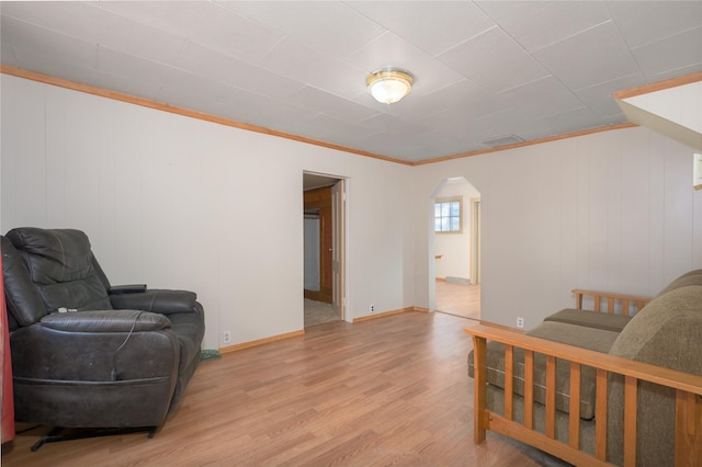 living area featuring ornamental molding and light hardwood / wood-style floors