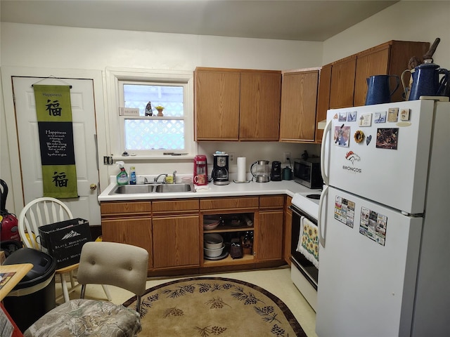 kitchen with white refrigerator, sink, and stove