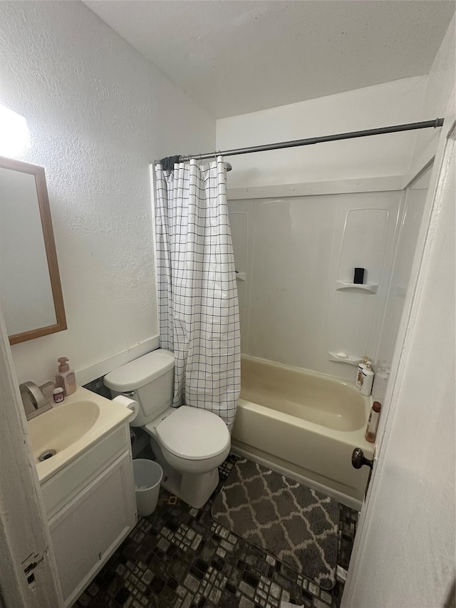 full bathroom with shower / bathtub combination with curtain, vanity, toilet, and a textured wall