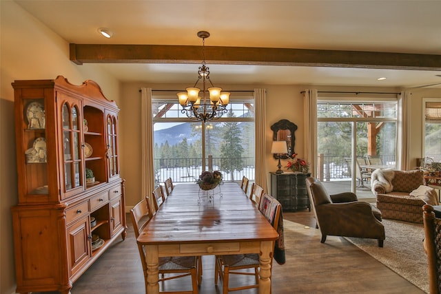 dining space with dark hardwood / wood-style flooring, a notable chandelier, and a mountain view