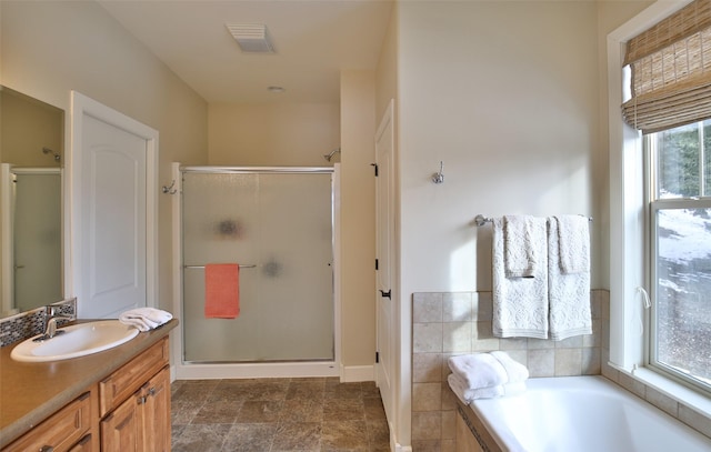 bathroom with vanity and independent shower and bath