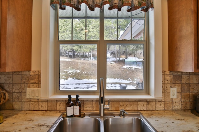 interior details featuring tasteful backsplash and sink