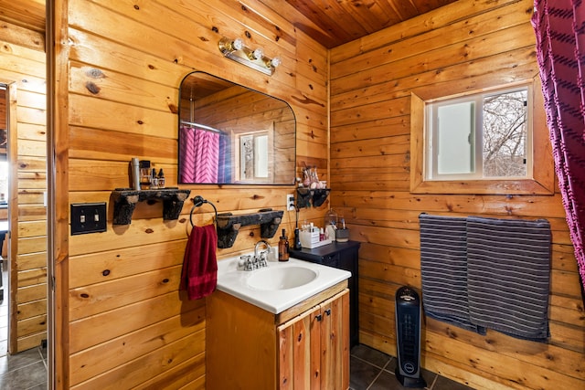 bathroom featuring vanity, tile patterned floors, wooden walls, and wood ceiling