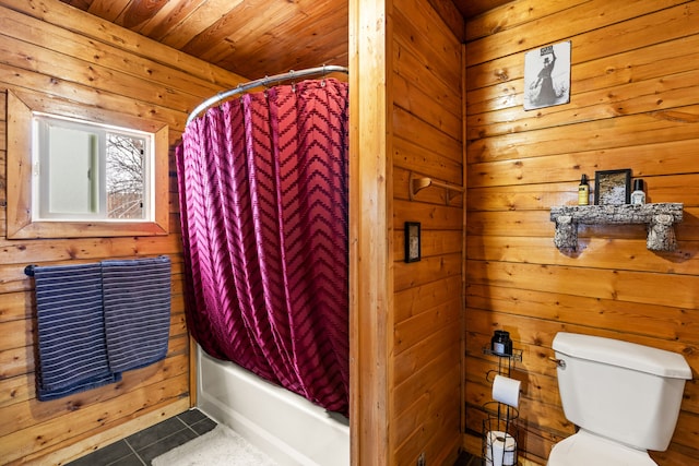 bathroom with shower / tub combo with curtain, wooden walls, tile patterned flooring, wood ceiling, and toilet