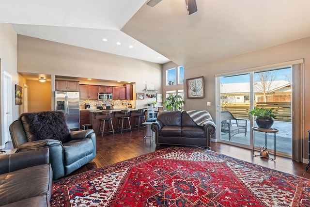 living room featuring lofted ceiling, dark hardwood / wood-style floors, and ceiling fan