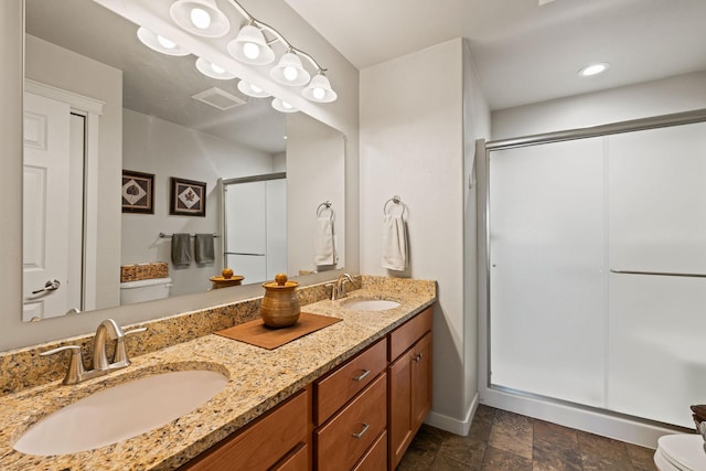 bathroom with vanity, toilet, and walk in shower