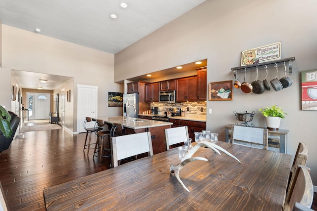 dining space featuring dark hardwood / wood-style floors and sink