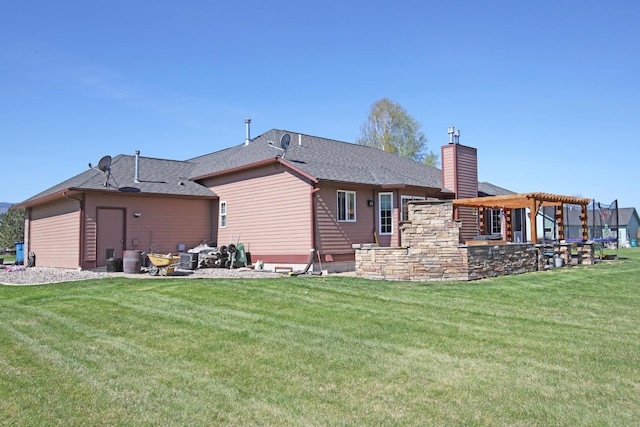 rear view of house with a pergola and a lawn