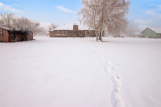 view of yard layered in snow