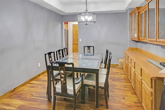 kitchen with a kitchen bar, sink, a center island, hanging light fixtures, and stainless steel appliances