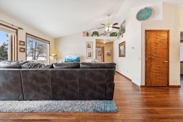 living room with dark hardwood / wood-style flooring, vaulted ceiling, and ceiling fan