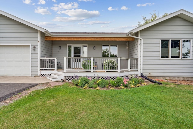 ranch-style house featuring a porch, a garage, and a front lawn