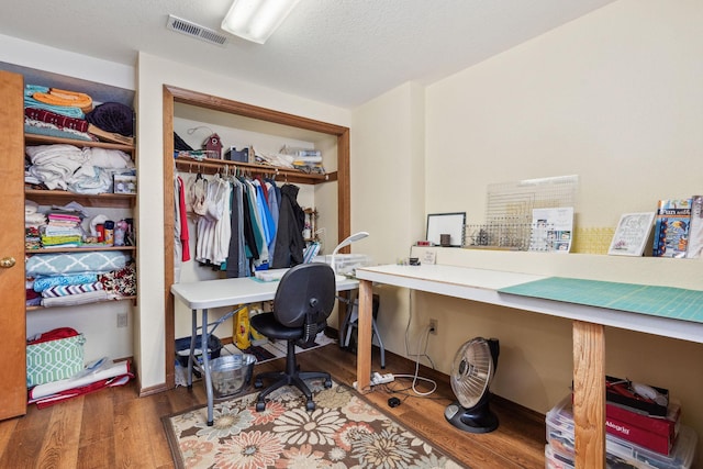 office area featuring hardwood / wood-style flooring and a textured ceiling