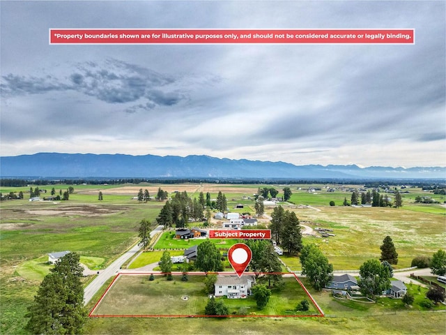 drone / aerial view featuring a mountain view and a rural view