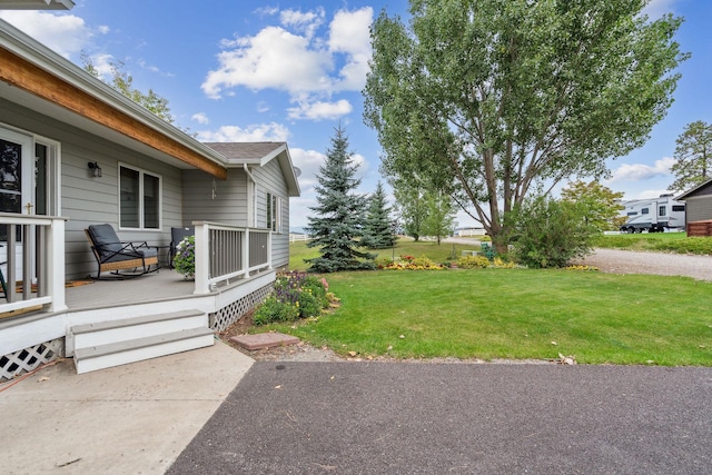 view of yard featuring covered porch