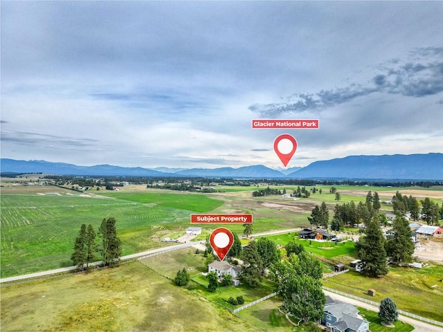 drone / aerial view featuring a rural view and a mountain view