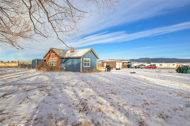 snow covered house with a mountain view