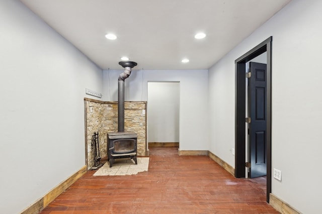 living room with hardwood / wood-style floors and a wood stove