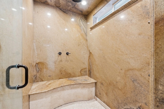 bathroom featuring a shower with door