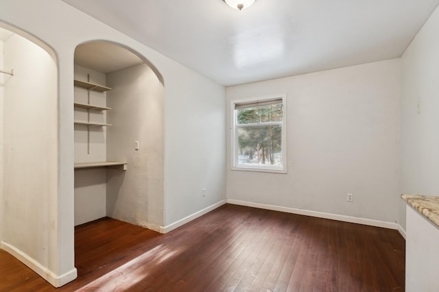 unfurnished room featuring dark hardwood / wood-style flooring