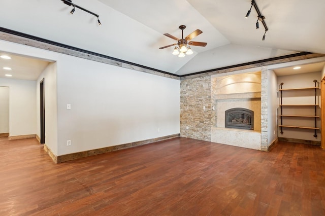 unfurnished living room with hardwood / wood-style flooring, lofted ceiling, and track lighting