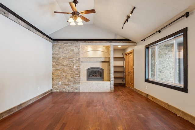 unfurnished living room with lofted ceiling, dark hardwood / wood-style flooring, rail lighting, and ceiling fan