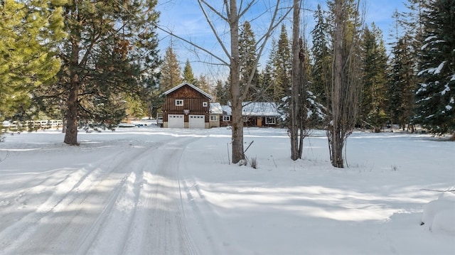 yard layered in snow with a garage