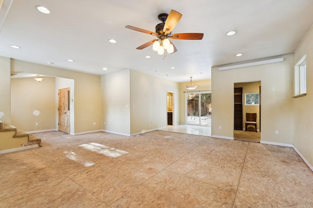 unfurnished living room featuring ceiling fan