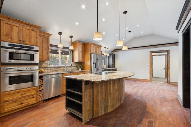 kitchen featuring sink, tasteful backsplash, a kitchen island, pendant lighting, and stainless steel appliances