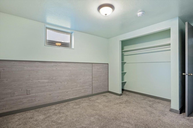 unfurnished bedroom with light carpet and a closet