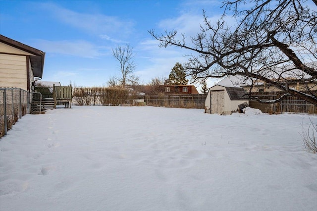 yard layered in snow with a shed