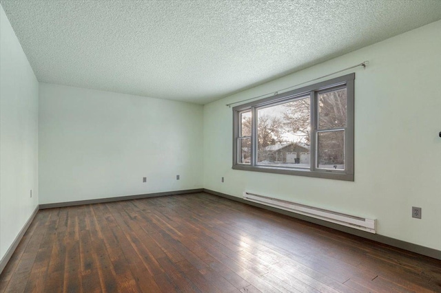 unfurnished room with a baseboard heating unit, dark wood-type flooring, and a textured ceiling